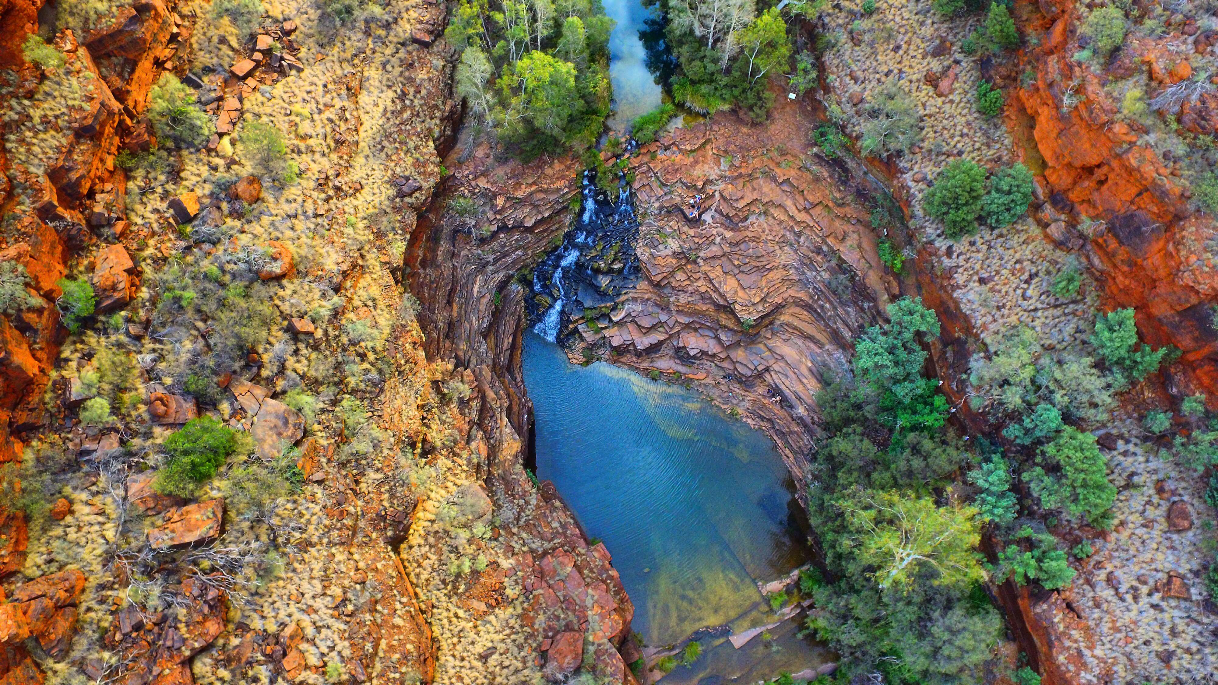 bright blue river flowing through a canyon