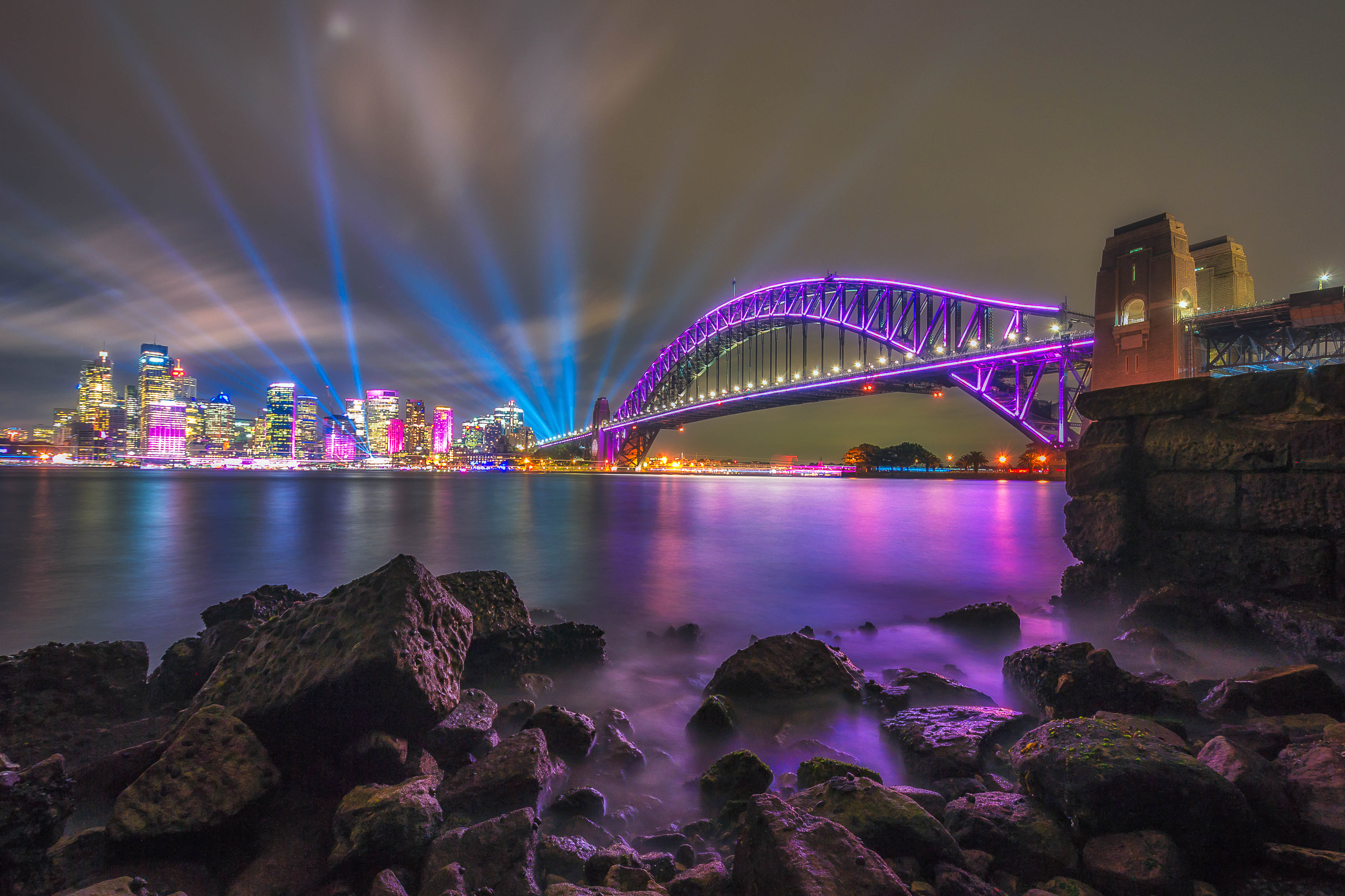 a city bridge lit up in purple