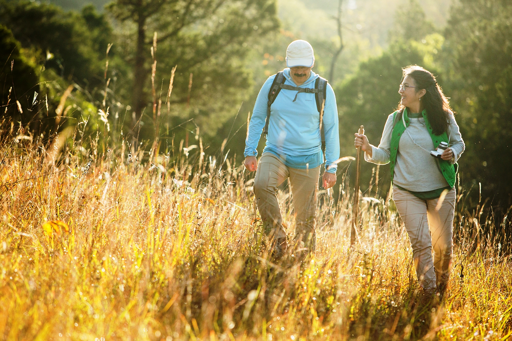 Hikers walking through grassland