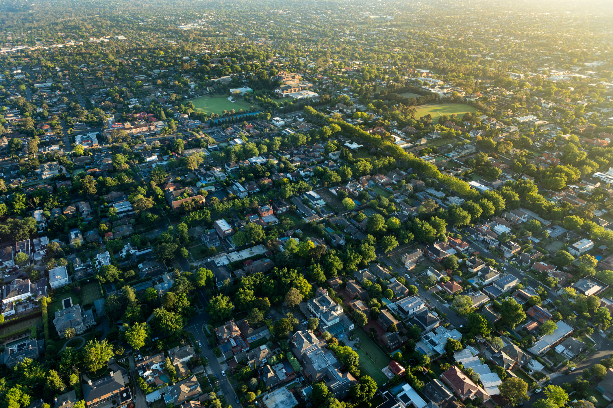 Aerial view of green Melbourne suburbs at sunrise