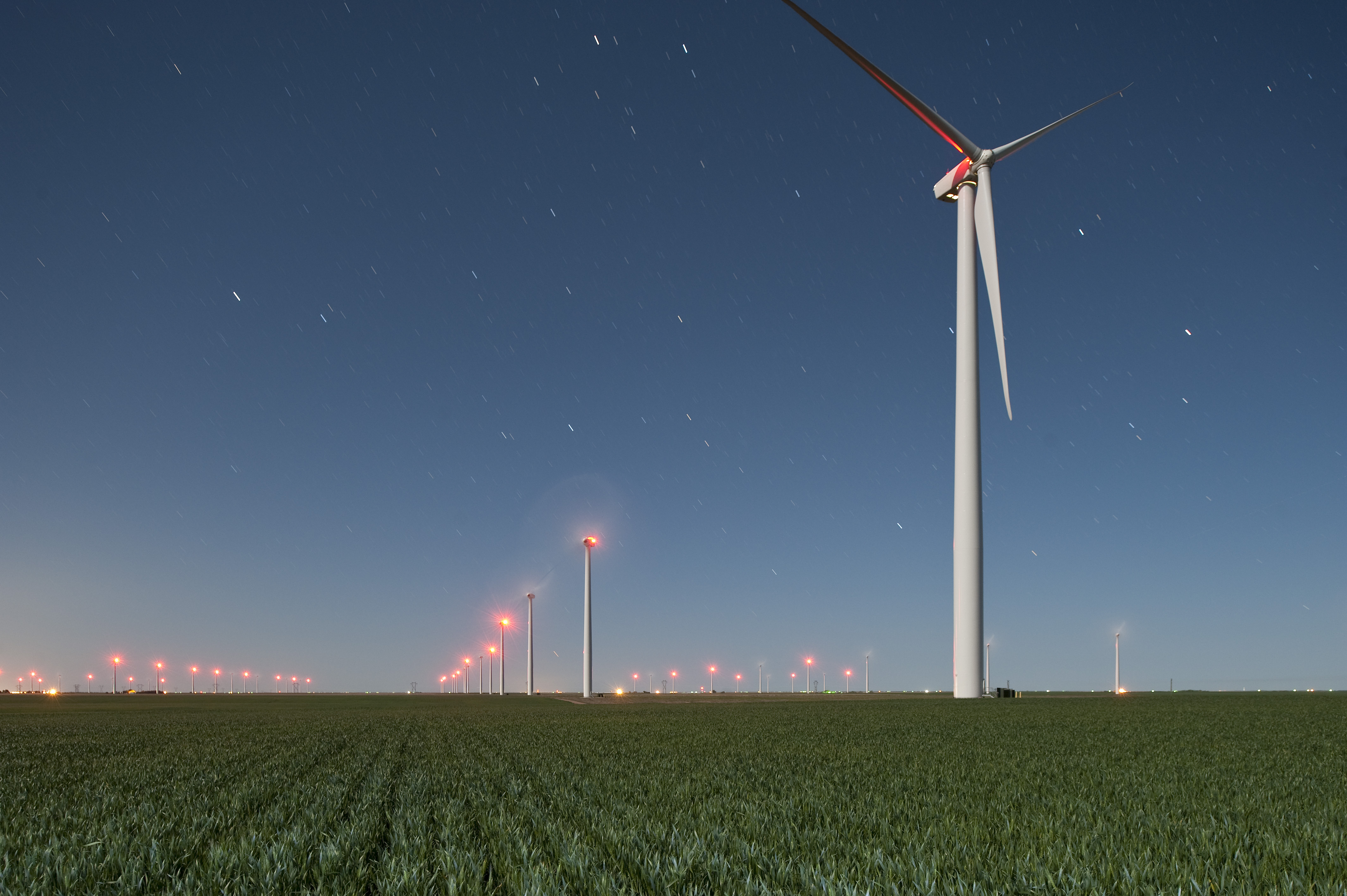 Rows of wind turbines across a Kansas farm create responsible and renewable wind energy.